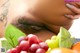 A close up of a woman's stomach with a bunch of fruit.