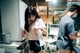 A man and a woman standing in a kitchen next to each other.